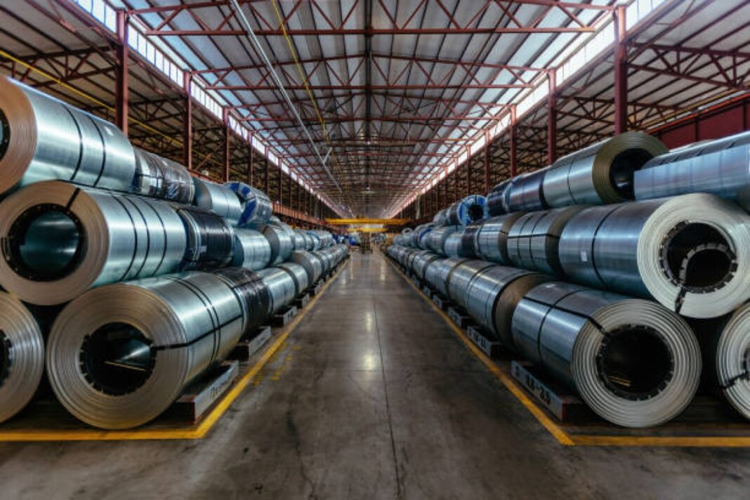 Rolls of galvanized steel sheet inside the factory or warehouse. Jindal Steel and Power (JSP), world's largest steel plant, Angul, Odisha, Naveen Jindal, economic impact, infrastructure, steel production capacity, sustainable practices, green energy sources, carbon emissions reduction, India's steel market, economic resilience, high-quality steel,