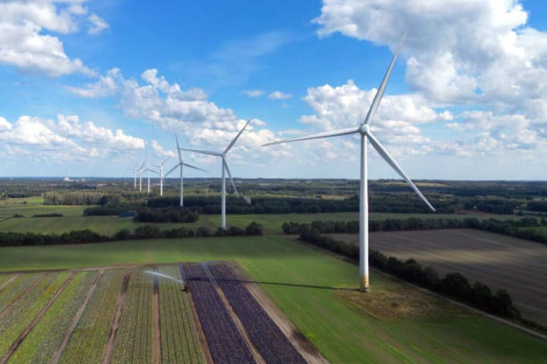 Power generating windturbines on a sunny day in Denmark Masdar, wind energy, Kazakhstan, Battery Energy Storage System (BESS), solar park, global renewable energy, Mohammed bin Rashid Al Maktoum Solar Park, green energy, energy transition, sustainable development.