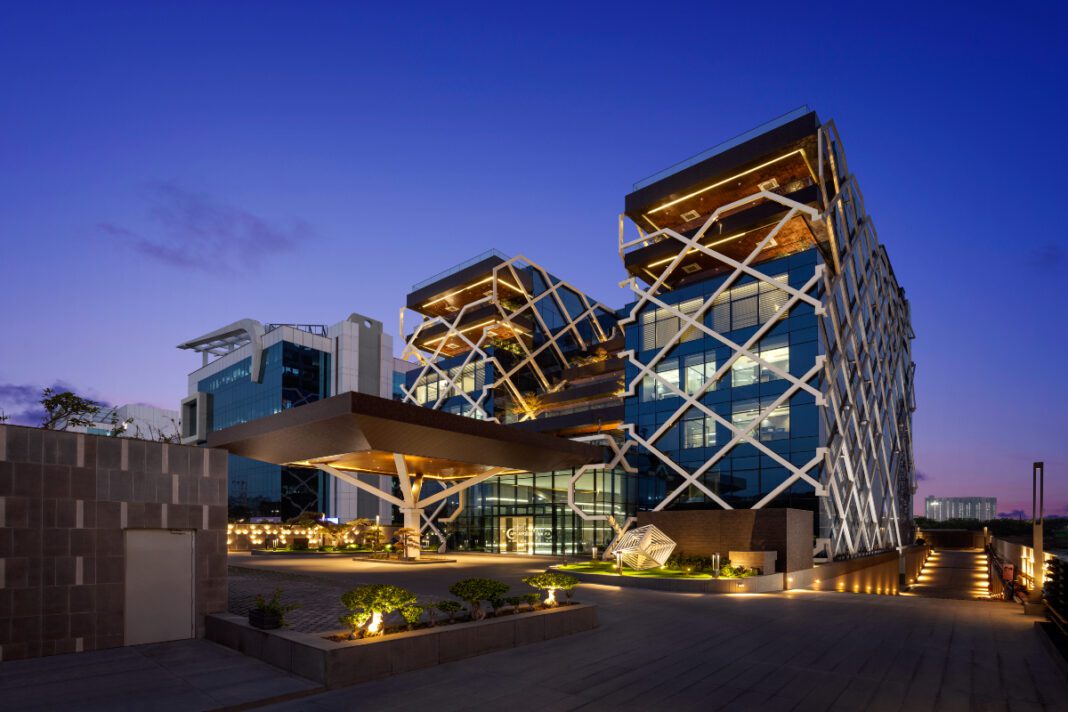 Steel exoskeleton, sustainable architecture, innovative design, modern workspace, Noida corporate office, 42mm Architecture, structural engineering, advanced construction, green terraces, architectural innovation, APL Apollo.