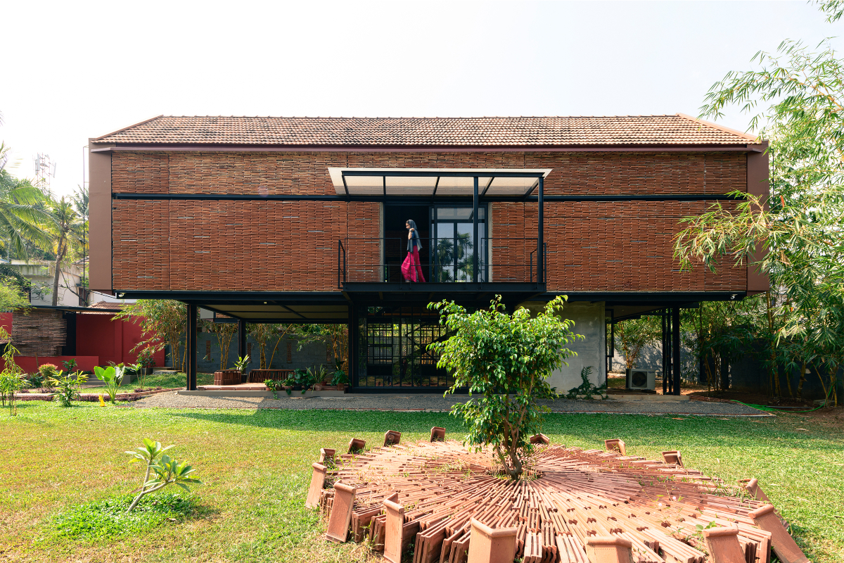Koshish House, Kochi, sustainability, architectural design, material reuse, terracotta tiles, steel repurposing, creative design, elevated structure, dynamic spatial experience, natural light, local collaboration, eco-friendly construction, modern architecture