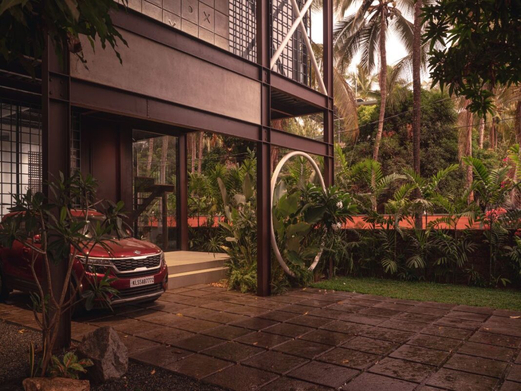 opening House XO, The XO Factor, industrial design home, contemporary urban living, sustainable home design, steel architecture, modern home Kerala, passive cooling design, prefabricated construction, minimalist architecture, urban loft style, eco-friendly home, steel-framed house, exposed concrete finish, open-plan layout, Kerala architecture, compact home design, sustainable building materials, rapid construction techniques, innovative home design, architectural sustainability