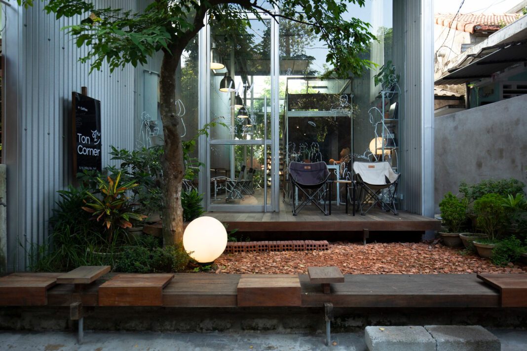 Sustainable design, Ton Corner Coffee Shop, Hue, steel structure, reclaimed wood, corrugated iron, minimalist architecture, eco-friendly, coffee shop, high-ceiling interior.