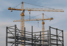 Static Crane Market Set to Climb with Steady Growth — Projected CAGR of 5.5% by 2031 A towering static crane at a bustling port, lifting shipping containers with precision under a clear blue sky